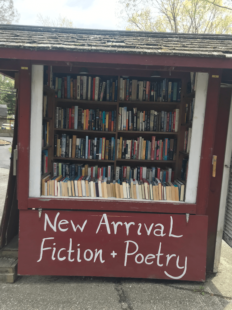 A red bookstand that says New Arrival Fiction + Poetry.