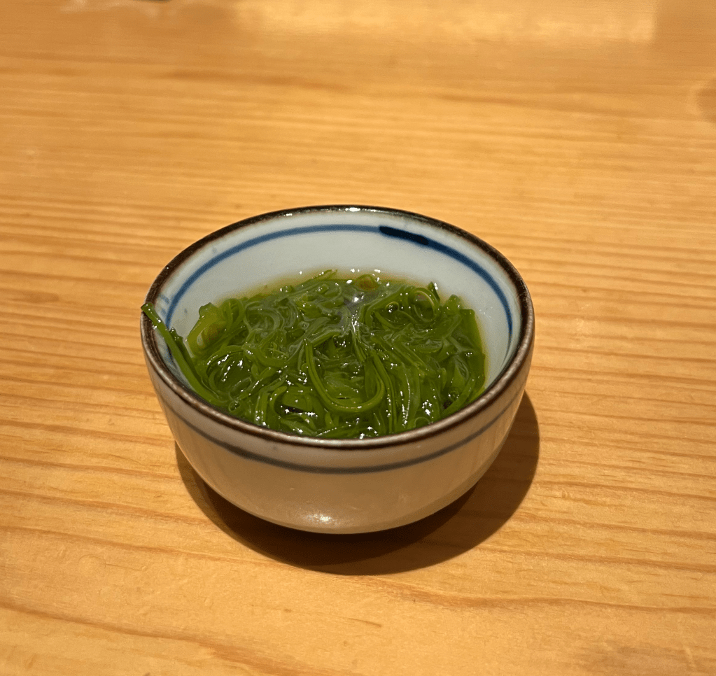 Seaweed salad in a small white bowl